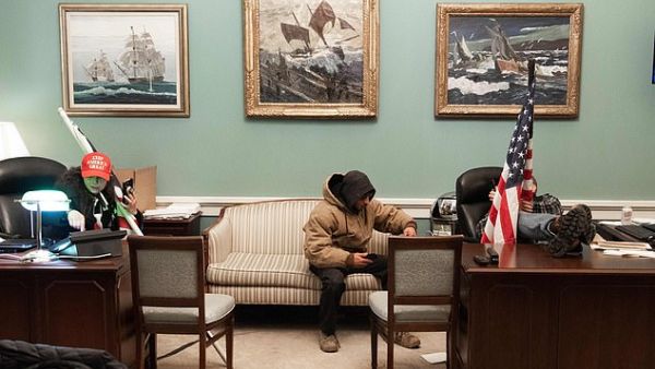 Trump supporters in their MAGA caps played with Pelosi's office furniture. (AFP)