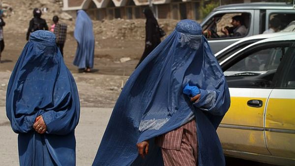 Two Afghan burqa-clad women walk along a street in Kabul, Afghanistan, on May 6, 2010 (AFP/file photo)