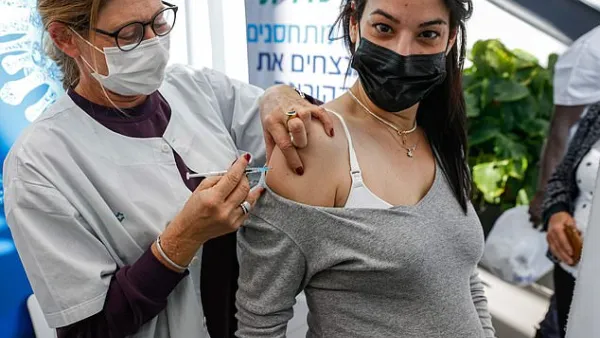 Pictured: A health worker administers a dose of the Pfizer-BioNTech COVID-19 at Clalit Health Services, in Tel Aviv, January 23. (AFP)
