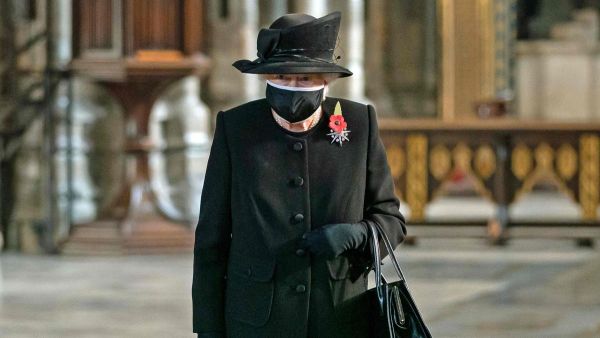 Queen Elizabeth II looks at the grave of the Unknown Warrior at Westminster Abbey during a service to mark the centenary of his burial ahead of Remembrance Sunday. AFP 