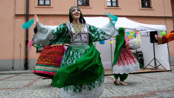Women dance Afghan folk dance in folk Afghan costumes on the Krakowskie przedmiescie street. (Shutterstock/ File Photo)