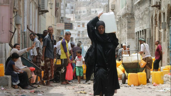 A Yemeni woman carries a plastic container filled with water in the southern Red Sea port city of Aden on July 19. (Saleh Al-Obeidi/AFP via Getty Images)