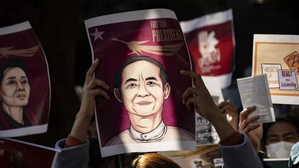Myanmar activists hold an image of their country's civilian president Win Myint as they protest outside the Myanmar embassy in Tokyo on February 7, 2021, after the country's military on February 1 seized power in a bloodless coup and detained its civilian leader Aung San Suu Kyi. Philip FONG / AFP