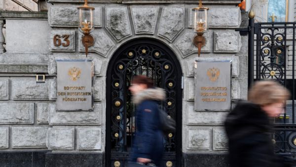 In this file photo taken on December 04, 2019 people pass by the Russian embassy in Berlin. Germany, Sweden and Poland on February 8, 2021 announced that they were each expelling a Russian diplomat in retaliation for Moscow's expulsion last week of their diplomats for allegedly taking part in protests in support of Kremlin critic Alexei Navalny. "Today the Federal Foreign Office has declared a staff member of the Russian embassy in Berlin persona non grata," the German foreign ministry said. John MACDOUGALL