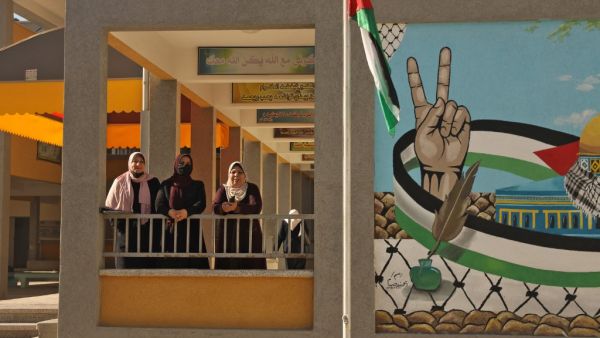 Palestinian teachers are pictured near the opening of the first Voter Information and Registration Centre in Gaza City on February 10, 2021. Rival Palestinian factions Fatah and Hamas said they had agreed on "mechanisms" for forthcoming elections and to respect their outcome, after years of bitter divisions. The parliamentary and presidential polls are set for May 22 and July 31, respectively. Mohammed ABED / AFP
