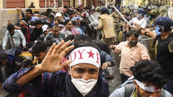 Leftist activists disperse as police baton charge during a protest against different policies of the Trinamool Congress (TMC) led state and Bharatiya Janata Party (BJP) led central government, in Kolkata on February 11, 2021. Dibyangshu SARKAR / AFP