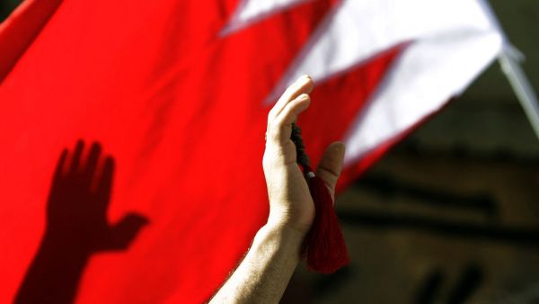  In this file photo taken on March 22, 2011 Bahraini Shiite wave a Bahrain flag as they attend the funerals of a man in central Manama. With a popular, reform-minded crown prince newly installed as prime minister, and a decade passed since the Arab Spring, Bahrain should be well placed to cast off the painful legacy of its uprising. The Pearl monument in downtown Manama -- the centre of the protests before they were crushed with the help of Saudi forces -- has long since been razed. But the nation's wounds 