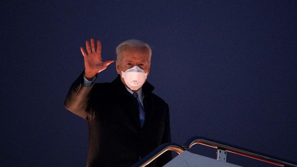 US President Joe Biden waves as he boards Air Force One before departing from Andrews Air Force Base in Maryland on February 12, 2021. Biden is heading the Camp David presidential retreat where he is due to spend the weekend. MANDEL NGAN / AFP