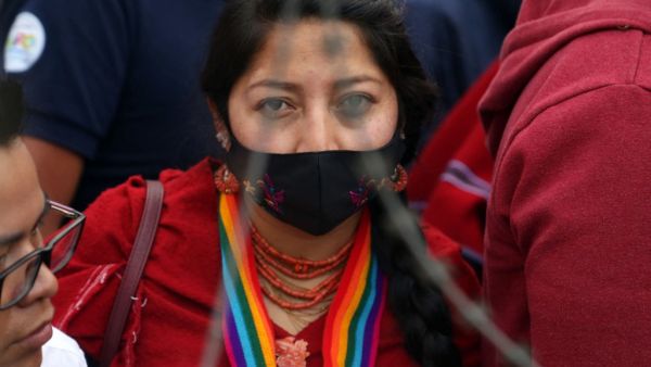A supporter of the Ecuadorian presidential candidate Yaku Perez takes part on a demonstration in front of the National Electoral Council (CNE), where Perez and his competitor Guillermo Lasso held a meeting with members of the CNE and the OAS, in Quito, on February 12, 2021. Former right-wing banker Guillermo Lasso and left-wing indigenous leader Yaku Perez, who are vying for the second place for Ecuador's presidential run-off election, agreed on February 12 at the Electoral Council to request a recount of v