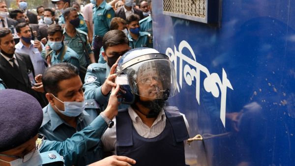 Police escort a convicted man (R) after a Bangladesh anti-terrorism court sentenced five Islamist extremists to death over the brutal murder of Avijit Roy, a Bangladeshi-US writer and rights activist, in Dhaka on February 16, 2021. sazzad hossain / AFP