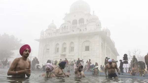 Sikh devotees take a holy dip in the Sarovar (water tank) during Basant Panchami celebrations at the Sikh Shrine Gurudwara Chheharta Sahib on the outskirts of Amritsar on February 16, 2021. NARINDER NANU / AFP