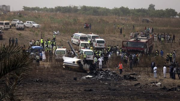 Caregivers work at the scene of an accident involving a Nigerian military aircraft which crashed killing seven occupants on board at the Airport runway near Nigeria's capital Abuja, on February 21, 2021. A Nigerian military aircraft Beechraft KingAir B350 has crashed killing seven personnel on board while returning to the Abuja Airport after reporting engine failure. KOLA SULAIMON / AFP