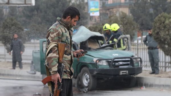 Policemen arrive at a site of a bomb blast which killed at least two people and injured five others, in Kabul on February 21, 2021. STR / AFP