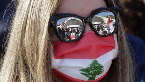 A Lebanese protester waits for the speech of Lebanon's Cardinal Mar Bechara Boutros al-Rahi (or Rai) on February 27, 2021 at the Maronite Patriarchate in the mountain village of Bkerki, northeast of Beirut. Thousands rallied Saturday in Bkerke north of Beirut, carrying Lebanese flags and portraits of Patriarch Bechara al-Rahi at the seat of the patriarchate. Earlier this month, Rahi had called for a UN-sponsored "international conference" in the face of the country's economic collapse and political impasse.