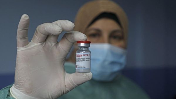 A Palestinian health worker holds vial of Covid-19 vaccine at Palestine Red Crescent hospital in West Bank city of Nablus, on 4 February (AFP/File photo)