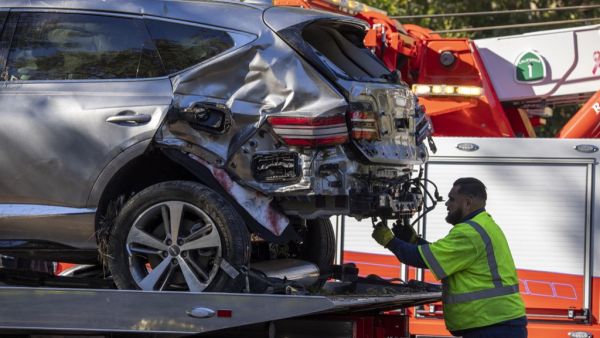 A tow truck operator secures the car that golf legend Tiger Woods was driving when seriously injured in a rollover accident on February 23, 2021 in Rolling Hills Estates, California. (Photo: AFP)