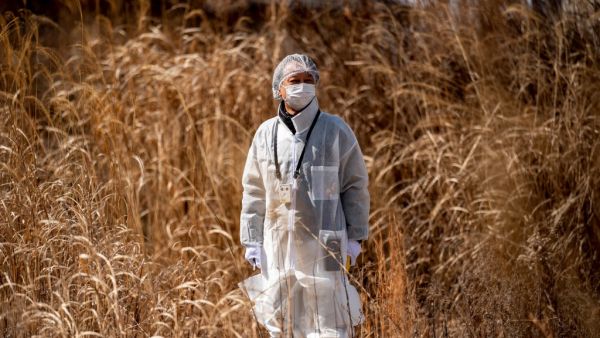 Reverend Akira Sato in a protective suit 