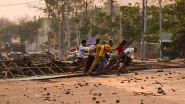 People run past makeshift barricades 