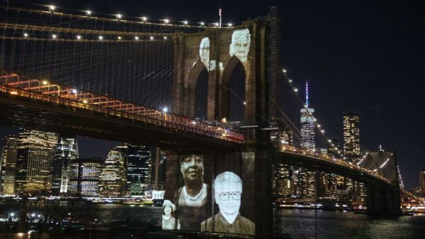Images of Covid-19 Victims projected over the Brooklyn Bridge