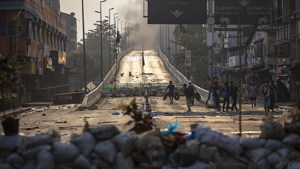 Protesters carry tires to construct makeshift barricades 