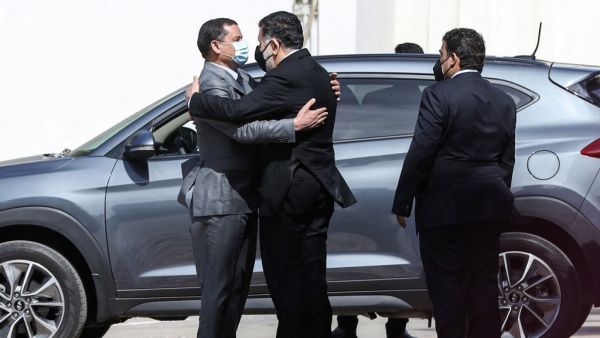 Mohamed al-Manfi (R), head of Libya's presidency council looks on as new interim Prime Minister Abdul Hamid Dbeibah (L) 