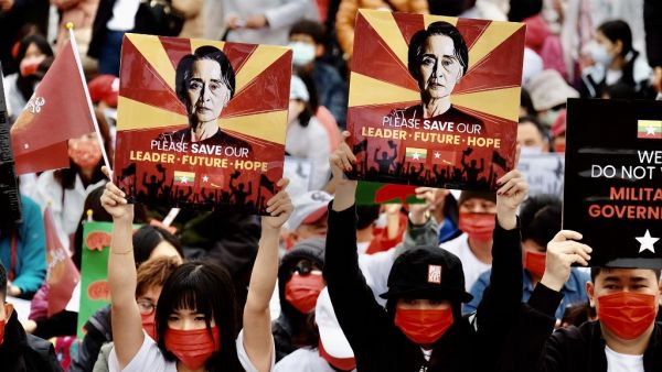 People from Myanmar living in Taiwan display portraits of their former leader Aung San Suu Kyi to protest against the military coup in their home country at the Free Square in Taipei on March 21, 2021. Sam Yeh / AFP Myanmar's military coup