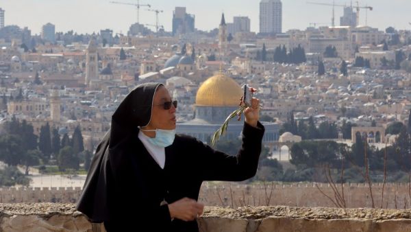 A nun takes a selfie during a Palm Sunday 