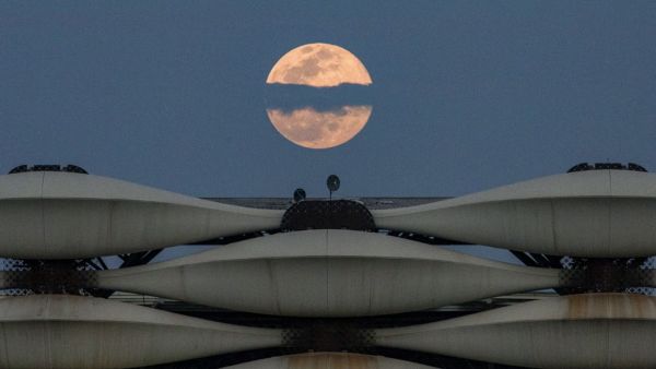  a view of the rising full "Worm Moon" above Basra International Stadium in the southern Iraqi city