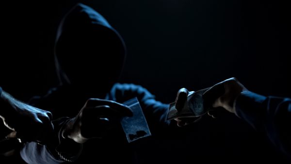 Police arresting drug dealer selling narcotic dopes to addict