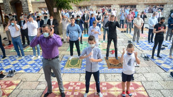 Muslims wearing protective masks whilst praying