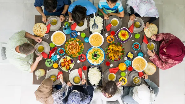 Family and friends gather at home to eat dinner