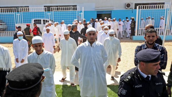 Prisoners of war, loyal to the forces of Libya's eastern military strongman Khalifa Haftar, are pictured upon their release by the new Libyan unity government on March 31, 2021 in the port city of Zawiya, 50 kilometres (30 miles) west of the Libyan capital Tripoli, following the latest peace deal between the North African country's former rival governments. The two sides have completed more than one prisoner swap this year as Libya's eastern administration officially handed over power to a new executive that is meant to unify the war-torn country and steer it towards elections late this year. The Government of National Unity (GNU), selected through a UN-supported process, is the latest internationally backed bid to end a decade of chaos in the North African nation and unite rival administrations.  Mahmud TURKIA / AFP Prisoners of war, loyal to the forces of Libya's eastern military strongman Khalifa Haftar