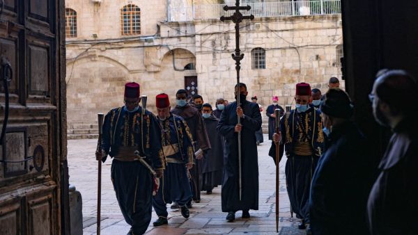 A procession enters the Church of the Holy Sepulchre in Jerusalem