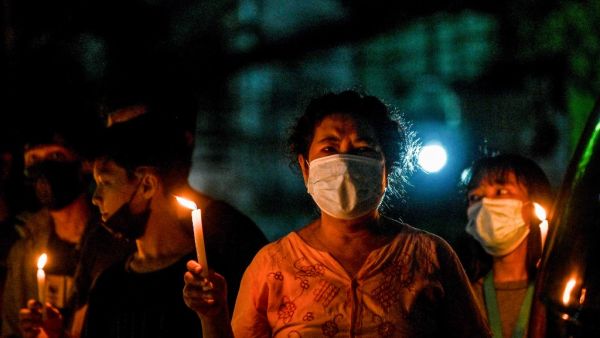  Protesters take part in a candlelight rally against the military coup in Yangon's Tamwe township
