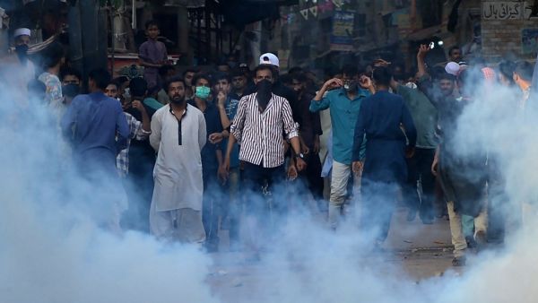 Police fire teargas shell towards supporters of Tehreek-e-Labbaik Pakistan (TLP) party during a protest after their leader was detained following his calls for the expulsion of the French ambassador