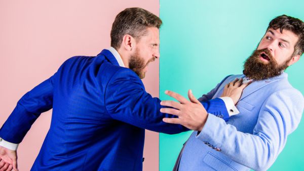 Business partners competitors office colleagues tense faces conflict situation