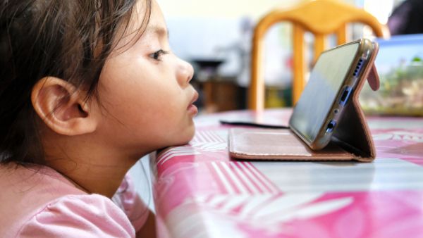 Young kids watching YouTube in smartphone gadget