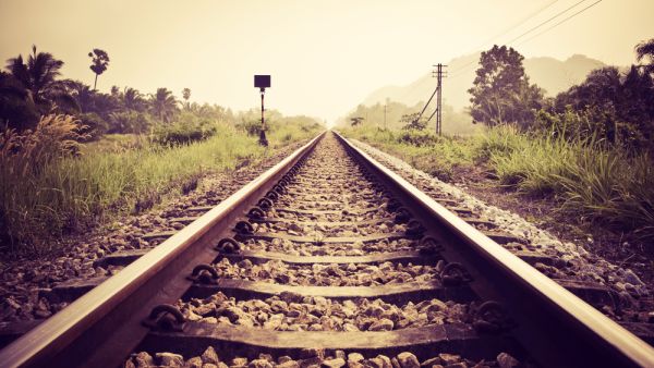 a viral TikTok of a man performing a dangerous stunt at a railroad 