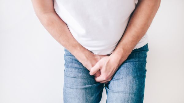 Guy hold both hands on crotch