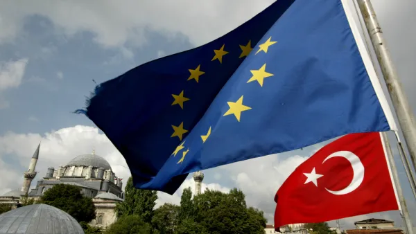 Turkish and EU flags seen in front a mosque in Istanbul