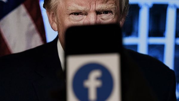  In this file photo illustration, a phone screen displays a Facebook logo 