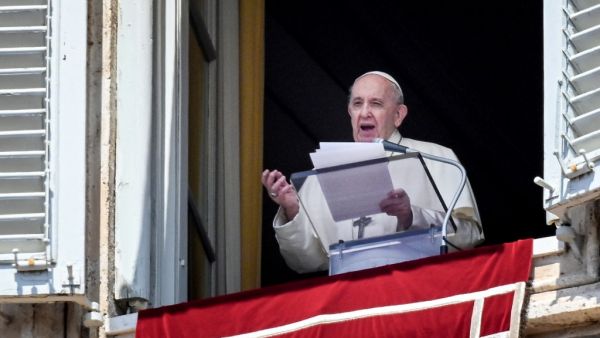 Pope Francis speaks from a window of the apostolic palace overlooking St. Peter's Square in the Vatican during the weekly Angelus prayer followed by the recitation of the Regina Coeli 