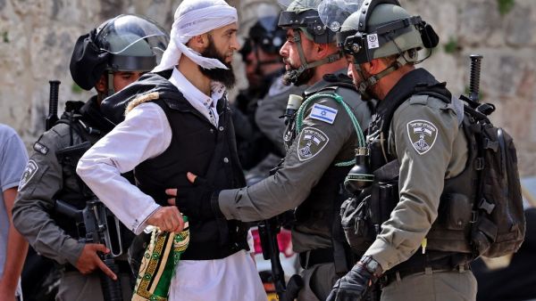 A Palestinian argues with Israeli security forces in Jerusalem's Old City on May 10, 2021, ahead of a planned march to commemorate Israel's takeover of Jerusalem in the 1967 Six-Day War. 