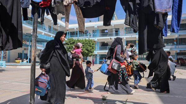 Palestinian families take shelter at a United Nations (UN) school in the southern Gaza Strip city of Rafah, on May 17, 2021, as Israeli air strikes hammered the Gaza Strip after a week of violence that has killed more than 200 people, the large majority Palestinian, despite international calls for de-escalation.