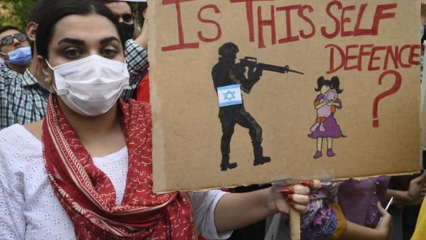 Demonstrators holding banners and placards take part in a protest rally against Israel's attacks on the Palestinian Gaza Strip in Lahore 