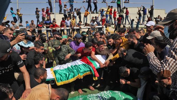Palestinians carry the bodies of members of the Ezz-Al Din Al-Qassam Brigades, the armed wing of the Hamas movement, who died in Israeli bombardment of a tunnel, during a funeral procession in Khan Younis, in the southern Gaza Strip