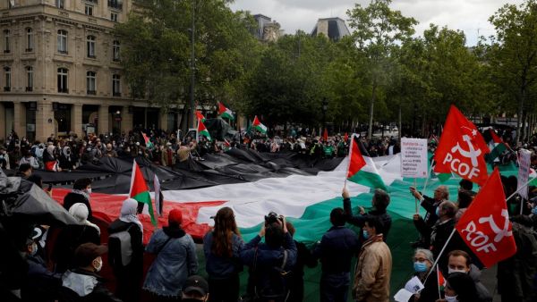 Protesters shout slogans and wave Palestinian flags during a demonstration in solidarity with the Palestinian people, in Paris on May 22, 2021. GEOFFROY VAN DER HASSELT / AFP Protesters demand 'sanctions on Israel' in France's capital