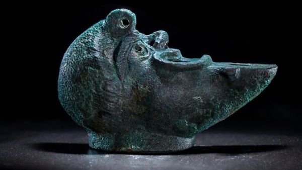 oil lamp shaped like grotesque face 