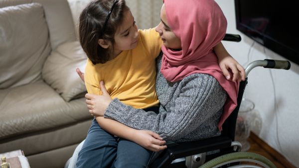 Muslim disabled young woman at home
