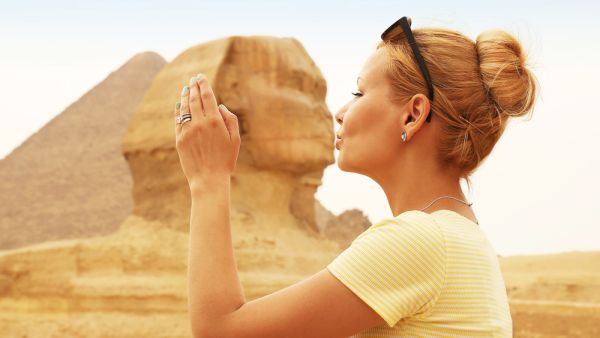 Tourist kissing the Sphinx, Cairo, Egypt